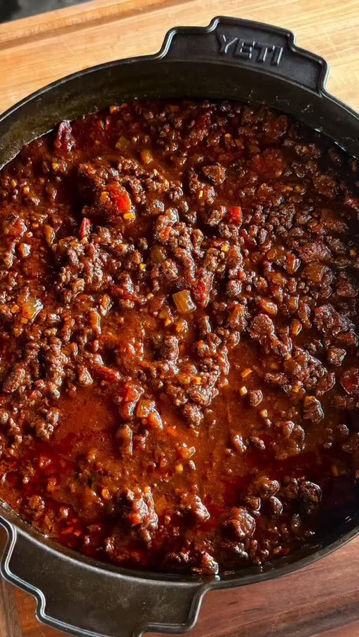 With the cooler weather we are bringing this Texas chili recipe back out. It’s flavorful and filling, and of course it can’t be called Texas Chili without emphasis of no beans. Recipe is below and on meatchurch.com

4 lbs of ground meat (venison is also great and is Matt’s fav)
1 lb of HOT breakfast sausage
3 medium red onions, diced
1 head of garlic, minced
84 ounces of tomatoes and sauce total. Use the below or interchange to your liking as long as you use at least 84 ounces)
2, 28oz can crushed tomatoes with juice
1, 28oz fire roasted diced tomatoes with juice
1 7oz can Chipotles in Adobo Sauce, diced. Preserve the liquid.
2 beers. 1 for the chili and 1 to drink while you’re making it. (sub beef broth)
5 T Meat Church Texas Chili Seasoning
1/3c olive oil
Garnish
Shredded cheese
Diced white onions
-Add the olive oil to a very large skillet. I prefer cast iron. Sauté the onions, garlic and adobo peppers
Cook for about 10 minutes until the onions are translucent. Remove from skillet and place the mixture in your slow cooker or dutch oven.
-Cook the ground meat and breakfast sausage completely in the same skillet. Drain the fat and place all of the meat in the slow cooker or dutch oven.
-By this time you already have the meat, onions, garlic and adobo peppers in your slow cooker or dutch oven. Now add the tomatoes with the juice, 1 beer and 5 T of Meat Church Texas Chili Seasoning.
-This chili can cook in 3 hours. However, it is better if you can cook it for 6 - 8 hours. The ingredients are already cooked at this point, but we will simmer this chili all day to break down the meat and meld the flavors together.
If you are using a slow cooker:
Cook the chili on low for 6 - 8 stirring periodically.
-If you are you are using a smoker:
Cook the chili at 225 for for 4-5 hours uncovered stirring periodically. Cover and continue to cook for 2-3 more hours. 
-Remove from the heat. Allow it to cool. Garnish and enjoy!

#MeatChurch #TexasBBQ #BBQ #TexasChilI