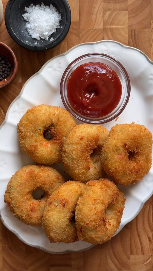 Crispy Chicken and Potato doughnuts 🥔🍗

Servings: 20-25 chicken doughnuts 

Ingredients:

1 lb boneless, skinless chicken breast, boiled and shredded
6 large potatoes, boiled
1/2 cup carrots, finely diced and boiled
1/2 cup bell pepper, finely chopped
1/2 cup green onion, finely chopped
1 cup mozzarella cheese, shredded
1 large egg
3 tbsp cornstarch
Salt, to taste
1 tbsp black pepper
1 tbsp garlic powder
1 tbsp chicken powder
2-3 Serrano peppers, finely chopped (optional)
1 tbsp fresh parsley, chopped
Oil, for frying

Coating:

1 cup bread crumbs
1/2 cup all-purpose flour + 1/3 cup water (to make thick slurry)

Instructions:

In a large bowl, combine potatoes, chicken, carrots, Serrano peppers, bell peppers, green onions, egg, cornstarch, salt, pepper, garlic powder, chicken powder, and cheese. Mix until well combined and sticky.
In a separate bowl, mix flour and water to form a thick paste.
In another bowl, add bread crumbs.

Shape potato-chicken mixture into doughnuts. Place them on a tray and Freeze them for 30 mins. 
Coat the chicken doughnuts in the flour mixture, then in bread crumbs.
you can Freeze the chicken doughnuts for later use at this point, or heat oil in a pan over medium heat. Drop in the dough and fry for 2-3 minutes, flipping sides, or until golden brown and crispy. Do not overcrowd the pan.

If air frying, lightly spray the chicken doughnuts with cooking oil and air fry at 400°F (200°C) for 10 minutes, flipping halfway.

#chickenandpotatoes #crispychicken #recipe