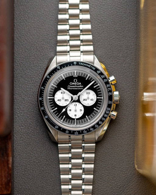 Today Omega is launching a new “reverse panda” dial variation of the iconic Speedmaster Professional Moonwatch. Taking cues from the 2024 white Speedy, this watch features a black lacquer dial in the step configuration, with applied markers and lume plots on the outer edges as well as a ceramic bezel. It’s reminiscent of the “Speedy Tuesday” limited edition in its general execution and brings a real pop of legibility to the Speedmaster lineup. Look closely and you’ll notice the “Professional” text is presented in the more classical serif typography. Inside beats the METAS-certified caliber 3861 present across the Moonwatch lineup. In addition to this steel version, Omega as also launched a Moonshine gold edition on a full Moonshine gold bracelet. Full details are on the site now. What do you think of this latest edition to the Speedmaster collection?