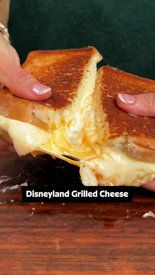 Just loooook at the cheese pull! 🤤🧀 For one of the best grilled cheese recipes you’ll ever try—straight from Disneyland—layer provolone and Cheddar slices with a  Cheddar and cream cheese spread on hearty white bread. 🏰✨

Keep reading to get the full recipe or click the link in the @allrecipes bio! 

Ingredients: 
4 ounces cream cheese, softened
2/3 cup shredded sharp Cheddar cheese
1 1/2 tablespoons heavy cream
1/2 teaspoon kosher salt, divided
1/2 cup mayonnaise
2 cloves garlic, finely minced
8 slices hearty white bread
8 slices sharp Cheddar cheese
8 slices provolone cheese

Directions:
1. Stir cream cheese, shredded cheese, heavy cream, and 1/4 teaspoon salt together in a small bowl until well combined; set aside.

2. Stir mayonnaise, garlic, and remaining salt together in a separate bowl; set aside. 

3. Place 2 slices Cheddar cheese on each of 4 pieces of bread. Spread cream cheese mixture evenly among the 4 Cheddar-topped slices; top each with 2 slices provolone cheese. Add remaining bread slices on top.

4. Spread half of mayonnaise mixture evenly over tops of sandwiches.

5. Heat a large nonstick skillet over medium heat. Place sandwiches in skillet, mayonnaise side down. Spread the top of each sandwich with remaining mayonnaise  mixture.

6. Cook sandwiches until golden brown on both sides, flipping occasionally until cheese is melted and bread is well toasted.

✨ Inspo: @stefantorres
🧑‍🍳: @nicolemcmom
#grilledcheese #copycatrecipes #disneyland #disneylandfood #disneysnacks disney cheese