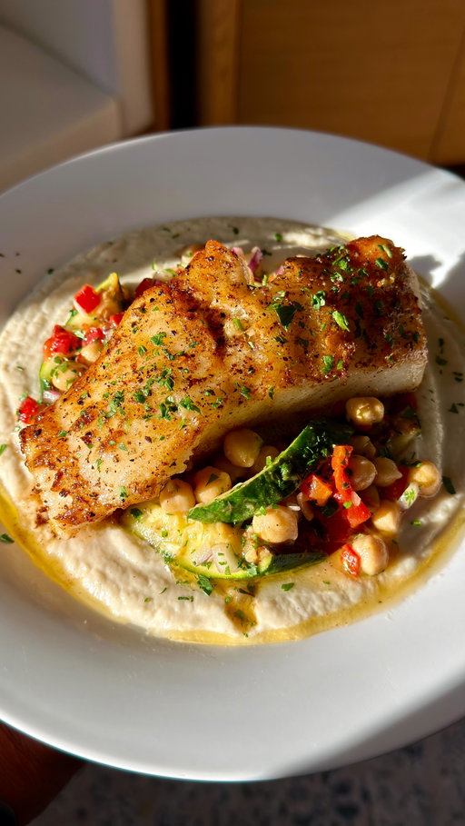 Sea bass with a vibrant, charred zucchini and chickpea salad. A light yet savory and satisfying dinner dish.
Recipe:
Salad:
1 (15 ounce) can chickpeas, drained 
1/3 cup roasted bell peppers in a jar, chopped 
1/4 cup parsley, chopped 
1/3 cup red onion, chopped
1 zucchini, chopped 
-Slice the zucchini in half and cross hatch the insides. Season with salt and set aside on a plate for 10 minutes to draw out excess water. In a cold pan, add oil and place zucchini facing down. Cover with a lid. Turn heat to medium high and sear. Remove and chop.

Dressing:
2 tablespoons red wine vinegar 
4 tablespoons olive oil 
2 garlic clove minced 
1 teaspoon dried oregano 
1/2 teaspoon Dijon mustard 
1/2 teaspoon salt 
1/4 teaspoon freshly ground black pepper 
 -Add all ingredients to a bottle and shake to mix. Add chickpeas and about 1/3 of the dressing to a large bowl and mix. Microwave for 90 seconds, mixing occasionally, and let sit for 20 minutes. 
-Mix in the remaining vegetables, and desired amount of dressing to create the salad. 

Pan seared sea bass: 
2 (6 oz) sea bass filets
Salt & pepper 
4 tablespoons butter
zest from 1/2 a lemon 
lemon juice for serving 
-Pat sea bass dry and season with salt and pepper. Let sit at room temperature for 20 minutes. In a pan over medium high heat, add oil and set fish down skin side down. Sear for 4 minutes undisturbed. Flip and cook undisturbed for 3 minutes. Lower heat to medium and add butter and lemon zest and baste for 2 more minutes. 

#easyrecipe #food #fish #healthy #recipe