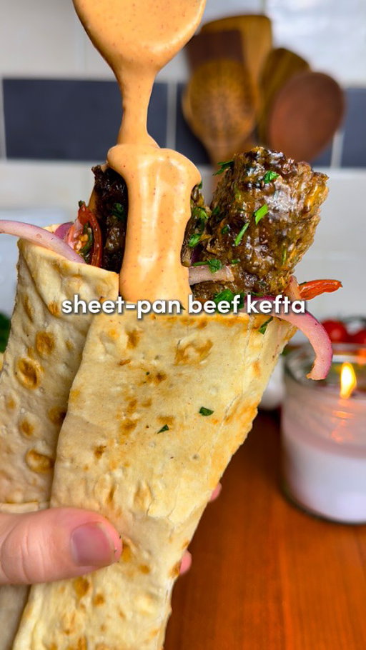 Sheet Pan Beef Kefta Wraps 🔥

All the flavor, none of the fuss… juicy spiced beef, roasted garlic sauce, & a zesty salad 

Comment “Recipe” and I’ll send you the full recipe card for free!!

For ALL of you asking for the app: search “osta recipes” on the app or google play store 🫶

For the Beef Kefta:
-1.5-2lbs lbs lean ground beef (700-900 g)
-8 garlic cloves, minced
-2 tsp smoked paprika, 2 tsp cumin, 1 tsp allspice, 2 tsp salt, 2 tsp black pepper, 1 tsp turmeric, 1 tsp cinnamon 
-1/3 cup fresh parsley, chopped
-1/3 cup fresh cilantro, chopped (optional)
-1 large or 2 medium yellow onions, grated + squeezed dry*
-On top before baking: 4 tbsp olive oil
For the Roasted Garlic:
-2 garlic heads, 1 tbsp olive oil and 1 tsp salt
For the Fresh Salad:
-1/2 large red onion, thinly sliced
-1 cup cherry tomatoes, quartered
-1/4 cup fresh parsley, chopped
-1 tsp salt, 1 tsp pepper & 2 tsp sumac
-Juice of 1/2 lemon
Roasted Garlic Paprika Sauce:
-Roasted garlic cloves, 1/2 cup Greek yogurt, juice of 1/2 lemon, 3 tbsp tahini, 2 heads of roasted garlic, 2 tbsp ice water, 1 tsp each: paprika, cumin, salt, pepper. Optionally add fresh chopped parlsey/cilantro.

1. Preheat oven to 400°F (205°C). Slice the tops off two garlic heads, drizzle with olive oil and salt, wrap in foil, & roast for 45–60 mins until golden and soft. While the garlic roasts, prep the kefta.
2. Grate the onion, squeeze out all liquid with paper towel or cheesecloth (prevents watery kefta.) In a large bowl, combine beef, garlic, spices, parsley, cilantro (if using), and the grated onion. Mix with your hands for 2–3 minutes until sticky & well combined.
3. Spread onto the sheet pan in a 1/2-inch (1.25 cm) thick rectangle. With a knife, score into 1-inch strips (2.5 cm). Drizzle evenly with 4 tbsp olive oil. Bake for 12–15 minutes at 400°F, then broil 2–5 minutes until golden & crisp on top. Careful removing!
4. Toss onion, tomatoes, parsley, salt, pepper, sumac, & lemon juice in a bowl.
5. Squeeze roasted garlic cloves into a bowl, mash, mix with yogurt, lemon juice, tahini, water & spices. On lavash/pita: add sauce, kefta, & salad. Roll tight. Crisp the wrap in a lightly oiled skillet.