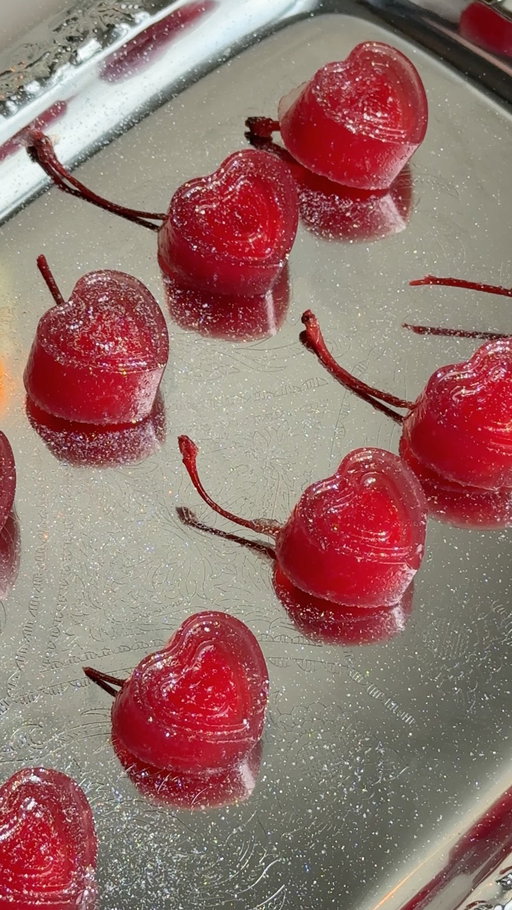 These cherry margarita Jell-O shots stole our hearts. 🥹🍒 Link for a similar heart shape mold is in our bio. 

@cocktails may earn commission through links in our socials. 

Ingredients:
- maraschino cherries with stems
- 1 oz. water
- 2 oz. fresh lime juice
- 2 packs unflavored gelatin (0.25 oz. each)
- 1/3 cup cherry juice
- 1/2 cup tequila
- edible glitter

Recipe:
1. In a pot, combine lime juice, water, and unflavored gelatin. Bring to a boil and continuously whisk until gelatin has dissolved. 
2. Remove from heat then add cherry juice and tequila. 
3. Whisk then pour 3/4 way into greased silicone heart mold. 
4. Add maraschino cherry with stem into each heart. 
5. Chill in the fridge for 3-4 hours. 
6. Carefully remove from mold and top with edible glitter for garnish. 
7. Enjoy!🍒

#cherry #margarita #jelloshots #heartshaped #valentine