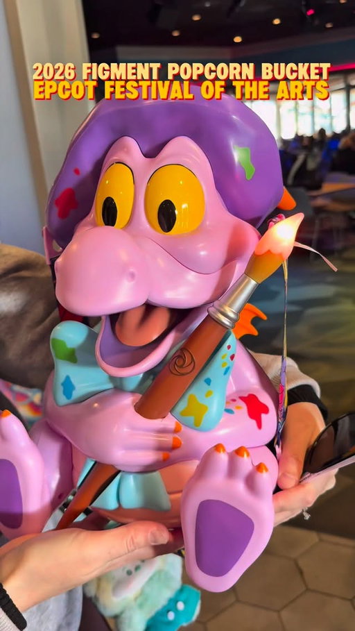The new 2026 Figment Artist popcorn bucket launched on January 16, 2026, at EPCOT’s International Festival of the Arts now thru February 23. The viral collectible bucket features the purple dragon dressed as an artist, complete with a beret and removable paintbrush that changes color.