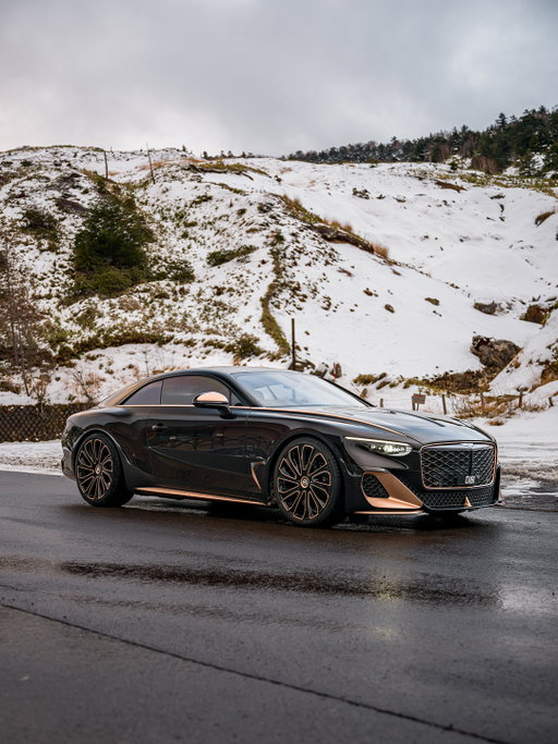 The unique Bentley Batur 'Black Rose' could be an exquisite objet d'art. Instead it emerges to light up Japan's winter roads.​

An edition of just 18 Baturs were built by Mulliner, each a wholly individual commission. The Black Rose uses intricately 3D printed rose gold – an industry first – for interior controls. ​

​Paintwork is shimmering bespoke Black Rose for the lower body, beneath a Beluga black roof. Rose gold accents include sills, vents, grille, the belt-line blade – even the under-surface of the deployable tail spoiler, a hidden delight. ​

The age old pleasure of personal craftsmanship meets Bentley's forward-facing design language and engineering. Bold yet restrained, it perfectly fits the wintry landscape and modern architecture of Karuizawa. Japan's is a culture that harmoniously respects both tradition and high-tech.​

​Imagery: @kenmsaito​

#Bentley #BentleyBatur