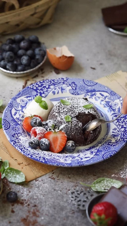 We’re expecting a lot of snow, which calls for some warm treat to enjoy with the family. These Chocolate Lava Cakes are gooey, decadent, comforting—just what the cold weather calls for! I hope everyone in the storm’s path stays safe and warm this weekend ❤️
 
Chocolate Lava Cake
 
Ingredients:
6oz (170g) semisweet chocolate*
6 tbsp (85g) butter
2 eggs
2 egg yolks
4 tbsp sugar
1/2 tsp vanilla extract
2 tbsp flour
1 tsp instant coffee (alternatively, 1 tsp orange zest)
Pinch of salt (2g)
 
For Preparing the Ramekins:
2 tbsp flour
1/2 tbsp cocoa powder
 
Instructions:
Preheat the oven to 450F.
 
Preparing the Ramekins: In a small bowl, mix the flour and cocoa powder. Butter 4 six-ounce ramekins and dust the inside with the flour mixture. Set aside.
 
Prepare the Lava Cakes: In a medium bowl, mix the flour, salt, and instant coffee. In another medium bowl, add chopped chocolate and butter and microwave in 30 second intervals, stirring between each, until melted and smooth. (You can also melt the chocolate using the bain-marie method.) Set aside.
 
Preheat the oven to 450F. In a large bowl, beat the eggs and sugar, using an electric mixer until pale and fluffy for 3-4 min. Add the vanilla. Pour the warm chocolate mixture into the egg mixture and mix until combined. Add flour mixture into the batter and fold just until combined. Divide the batter among the prepared ramekins and place them on a baking sheet. Bake for 5 min at 450F, then reduce the heat to 400F, and bake for an additional 4-5 min. Remove from the oven immediately. Using a kitchen cloth or oven gloves, turn each cake out onto small plates. 
 
Dust with powdered sugar and serve immediately, with fresh berries and ice cream or whipped cream.
 
Bon appétit!
 
*Notes: Your cakes should be firm on the outside, but the center should be soft and molten with flowing chocolate.
 
*If you don’t like the bitter-sweet taste, you can use 3 oz semisweet chocolate and 3 oz milk chocolate. If you are going to use milk chocolate, you can reduce the amount of sugar a bit.