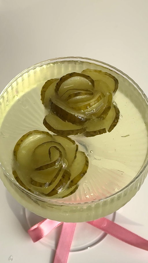 Chivalry ISN’T dead.😌 Send this to a pickle lover who deserves a martini. 🥒💐

Pickle Flower Ice Cubes:
- pickle slices layered in a half sphere silicone mold
- pickle juice

Pickle Dirty Martini
- 2.5 oz. vodka or gin.
- .25 oz vermouth
- .5 oz. olive brine
- .5 oz. pickle brine

#pickles #flower #icecubes #valentines #dirtymartini