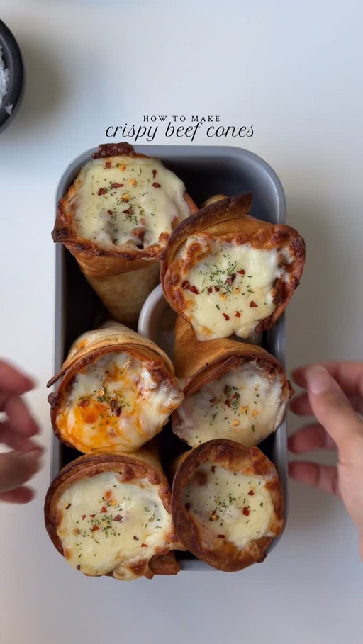 Crispy Beef Cones 🍦

Ingredients

For the beef mixture:
1 lb. ground beef, 80% lean 20% fat
1 small yellow onion, finely chopped
1 tbsp fresh garlic, minced 
4 tbsp tomato paste
Salt to taste
1 tsp black pepper 
1 tsp garlic powder 
1 tsp smoked paprika powder 
1/2 tsp red chili powder 
1 tsp red chili flakes
1 cup water
1 cup mixed bell peppers, diced
1-2 Serrano peppers 
2 tbsp oil

To assemble:
8 medium tortillas, halved
8oz Tillamook Farmstyle Mozzarella Shredded Cheese
1 tsp dried parsley for garnish 
Cooking spray 
Toothpicks

Instructions:

In a pan, heat oil on medium heat. Once the oil is hot, add chopped onions and garlic. Sauté for 1 to 2 minutes until the onions become translucent. Then, add and sauté the beef for 2 to 3 minutes until it changes color. Add salt, pepper powder, red chili powder, garlic powder, and red chili flakes. Mix well and cook for 1 to 2 minutes until the spices are well combined. 

Add the tomato paste and stir until it’s fully incorporated. Then, add the water. Cover the pan and stir occasionally until the mixture thickens. This should take about 10 to 12 minutes. Once the water has mostly evaporated and the beef is cooked, add the bell peppers and Serrano peppers cook for 3 to 4 minutes. Remove the pan from heat and set it aside.

Preheat the oven to 400°F and line a baking sheet with parchment paper.
Shape each tortilla half into a cone and secure the seam with a toothpick. Lightly spray the outside of each cone with cooking spray.

Place cones seam-side down on the baking sheet.

Bake empty cones for 8-10 min until golden and crisp. Fill each cone with the beef filling and cheese. Stand each filled cone upright in a loaf pan, bake the cones for 8 to 10 minutes or until the cheese is melted and bubbly. Garnish with parsley and serve warm.

#beefcones #recipe #gamedayrecipes