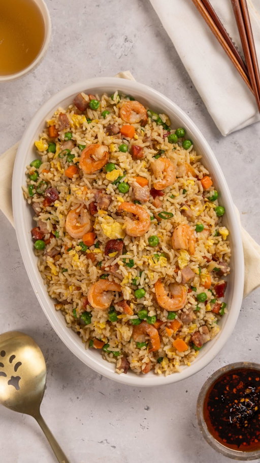 Leftovers never tasted so good 🤤🍚 @matthewchincreative 

RECIPE

Ingredient list:
● 3 tbsp neutral oil
● 1 cup shrimp
● 1 cup pork or any leftover meat, diced
● 1 cup mixed vegetables
● 3 eggs
● 3 cups leftover rice
● 2 tbsp soy sauce
● Salt and white pepper (or black pepper) to taste
● 1 tbsp sesame seed oil
● 2 tbsp green onions

Instructions:

1. In a large frying pan or wok, pour 1 tbsp oil.
2. Add your shrimp and season with salt and pepper. Stir, then add leftover meat and mixed vegetables.
3. Stir until moisture evaporates and remove from the pan.
4. Add remaining oil, whisked eggs and pour into the pan. Scramble eggs using a spatula and set to one side of the pan.
5. Add rice and mix well, breaking up any clumps in the rice.
6. Add filling back to the pan and mix until well combined.
7. Add soy sauce and toss to combine.
8. Remove from heat, add sesame seed oil, green onions, remove mix and serve.