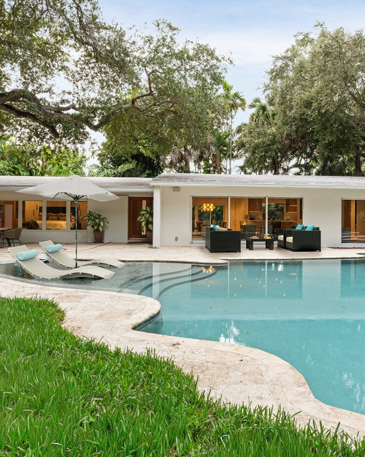A refined take on mid-century modern living, this reimagined Miami Shores residence east of Biscayne blends timeless design with contemporary luxury. Set on an expansive lot, the four-bedroom, three-bath home is filled with natural light from floor-to-ceiling impact glass and features custom European millwork, elevated lighting, and a chef’s Italian Stosa kitchen with premium appliances. The serene primary suite offers a spa-inspired bath and tranquil garden views, while smart-home enhancements add effortless sophistication throughout. Outdoors, a heated pool and jacuzzi, coral stone driveway, and majestic oak canopy create a private tropical retreat.⁠
•⁠
•⁠
•⁠
•⁠
Represented by Miami Agents Carlo Dipasquale and ⁠
Brian Rokicki⁠
1075 Northeast 99th Street, Miami Shores, FL