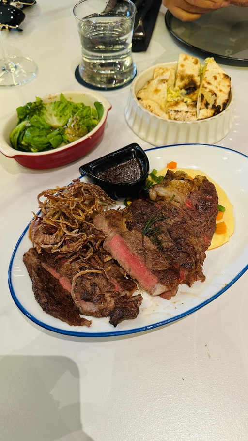This newly opened spot in Vertis North seriously blew me away:  moody, cinematic vibes + premium steaks = love at first bite. 🖤🥩

📍 Black Bull Steakhouse & Bar Ayala Malls Vertis North

What we ordered: • Greek Pockets Salad • Beef & Onion Pizza • Ribeye Steak (1/2 lb) • Miso Banana Brulee
#foodreviews #quezoncity #datenightideas
