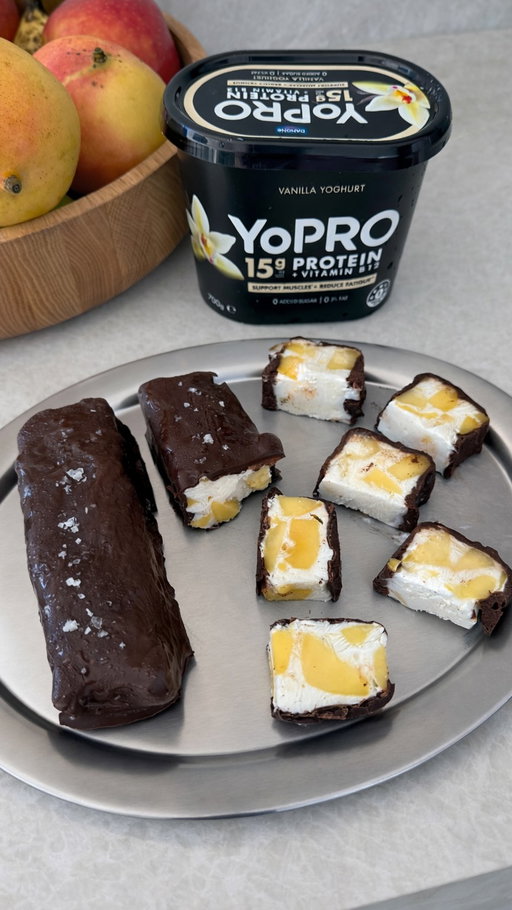 MANGO YOGHURT BARS 🥭 using @yoproau yoghurt
Such a delicious & easy snack.  Recipe Inspiration by @amal.wakim 💙
Ingredients:
Makes 6 bars
500g YoPRO Vanilla yoghurt
2 ripe mangos, diced
30g honey
1/4 cup coconut shavings
1tsp vanilla extract
Pinch of salt
Chocolate shell:
200g sugar free dark chocolate
1tbsp coconut oil
Instructions:
In a bowl, combine yoghurt, honey, coconut and vanilla until smooth.
Gently fold in diced mango.
Line a loaf tin with baking paper and spread the mixture into the pan.
Freeze until completely firm, ideally overnight.
Lift out and slice into bars.
Melt chocolate with coconut oil until smooth.
Dip each bar to coat, then place on a lined tray.
Sprinkle with a little sea salt, then freeze again for 10–15 minutes to set.
Store in the freezer and let sit at room temp for a few minutes before eating for the best texture.
#ad #YoPRO #FeedYourProgress #MangoRecipe.