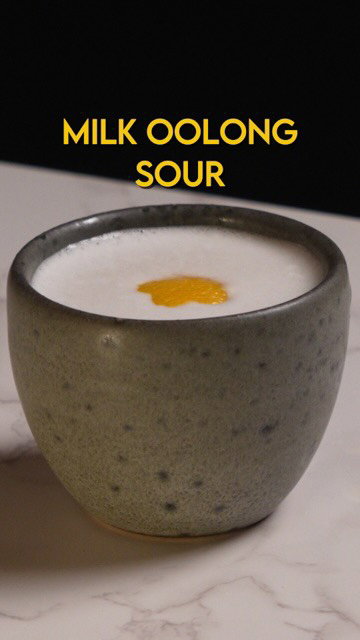 Milk Oolong Whiskey Sour

Milk Oolong infused bourbon, Amaretto, Lemon, eggwhite

A floral, buttery take on the classic, layered with stone fruit and subtle almond notes. Milk oolong–infused bourbon forms the base, finished with amaretto and lemon for balance and texture. The flavor evokes Chinese Almond tofu. In the future I might try to bring a bit of osmanthus into the picture as a garnish or aroma

2 oz Milk Oolong Bourbon

0.5 oz Amaretto

.25 oz rich syrup

.75 oz lemon juice

.5 oz eggwhite

Add ingredients to a shaking tin, dry shake to incorporate egg white, and then add ice and shake until cold. Strain into a teacup. Garnish with lemon coin.

Milk Oolong Bourbon

5 g Milk Oolong

250 ml Bourbon

Add ingredients together and let it sit for up to 2 hours, then strain and reserve .

#cocktails #drinks #mixology #bourbon #tea