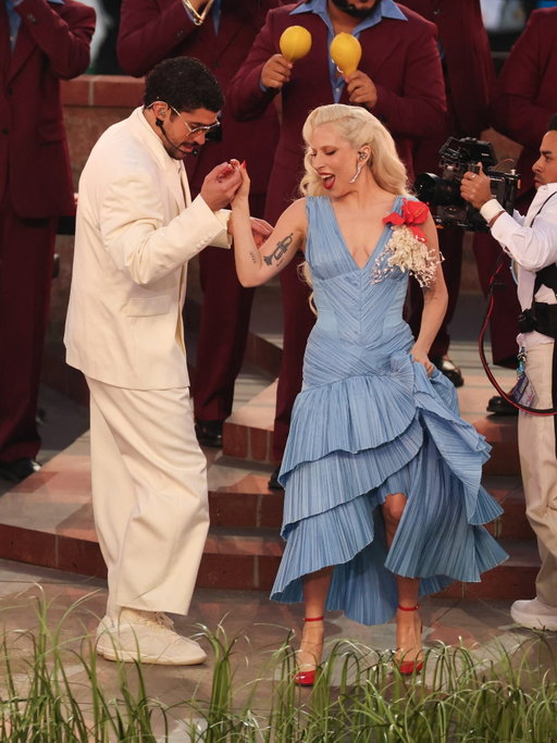 Lady Gaga performs at the 2026 Super Bowl Halftime Show in a custom blue Luar gown with a Flor de Maga corsage and Chopard earrings

#LadyGaga #SuperBowl