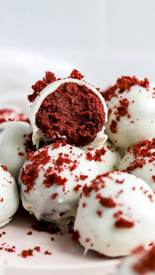 3 Ingredient Red Velvet Cake Balls ❤️‍🔥

Moist cake (so sorry for using the M word) mixed with cream cheese frosting all wrapped up in white chocolate?! Name something better. 

INGREDIENTS -
1 box red velvet cake mix, I used Betty Crocker
1/3 cup cream cheese icing, I used Betty Crocker
1 bag white candy melts, 12 oz

DIRECTIONS -
1) Start by preparing your cake by package directions. Beat cake mix, water, vegetable oil, and eggs in a large mixing bowl.
2) Pour the batter into a greased 8x8 inch baking dish and bake in a 350 degree F oven until a toothpick inserted into the center comes out clean.
3) Let the cake cool completely, then crumble it with a fork in a large bowl or in the baking dish. Set aside 1/3 cup of crumbled cake to decorate the outside of the cake pops.
4) Stir the frosting into the crumbled cake, cover with plastic wrap, and freeze until chilled.
5) Use a cookie scoop and your hands to roll the mixture into evenly sized small balls and place on large baking sheet. You want to try make them all a consistent size – aim for the size of a ping pong ball.
Freeze again until balls are hard.
6) It’s easier to roll the cake & frosting mixture into perfectly round balls if it’s cold. The cake & frosting mixture is super moist, and at room temperature it makes it extremely difficult to shape them perfectly.
7) Once they have been frozen, I give them another little roll to smooth out the sides. Then place on a cookie sheet. 
8) Melt candy melts in the microwave in 30-second intervals or in a double boiler. 
9) Place the dough balls into a fork and lower into the melted chocolate. Tap the fork onto the bowl to let excess chocolate drip off. Transfer back to cookie sheet and add red velvet cake crumbs on top of the truffles immediately.
10) Repeat until all the balls have been dipped. If the chocolate begins to thicken up, add back to microwave for 15 seconds so it’s easier to use.
11) Allow balls to sit at room temperature until they are solid. There you have it, you have easy red velvet balls!

#redvelvetcakes #redvelvetcakeballs #cakeballs #cakepops #cakepoprecipe