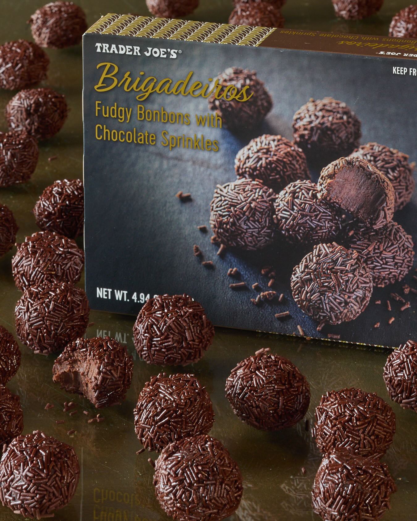 If you ever have the good fortune to attend a party in Brazil, your chances of spotting #Brigadeiros on the sweets table are deliciously high. (Lucky you!) These soft, fudgy, chocolate-sprinkled bonbons are a beloved part of Brazilian culture—and once you sink your teeth in, it’s easy to understand why. 😍
•
Brigadeiros (prounounced “bree-gah-DAY-ros” in Brazilian Portuguese) trace back to the 1940s. They’re widely linked to the 1945 presidential campaign of Brigadiero Eduardo Gomes, whose supporters made and sold the treats to raise funds. Gomes didn’t win the election, but his namesake sweet became a lasting favorite—maintaining a ubiquitous presence at parties, social gatherings, and joyful occasions for 80 years and counting!
•
The popularity of this treasured treat continues to proliferate throughout Brazil and beyond—including the freezers at your neighborhood #TraderJoes, where they're available for your enjoyment all year long! Our version is made in classic style, with sweetened condensed milk, cocoa, cream, and cultured butter, then rolled in chocolate sprinkles for a satisfyingly textural finish. Happy Valentine’s Day! 💕
—
• 9 per Box • Thaw & Serve • #TJsFreezerFinds •