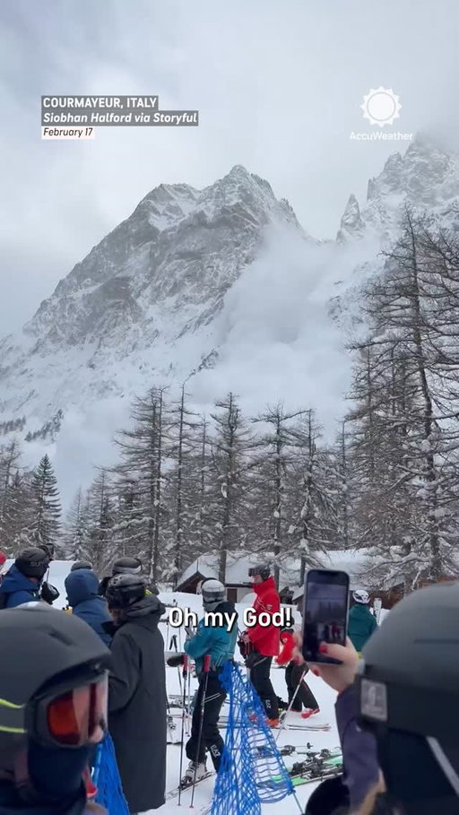 Video captures the tense moment a cloud of avalanche dust engulfs skiers waiting in line for a chairlift at a ski resort in northern Italy.