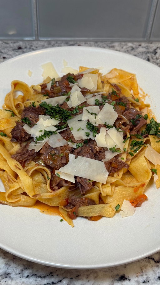 New house, new recipe, same great taste. Especially when the food is beef! @beefitswhatsfordinner ⬇️ Recipe ⬇️ #BeefFarmersandRanchers #ad

Beef Short Rib Ragu:
3 to 4 lbs bone-in beef short ribs
salt and pepper to taste
2 tbsp olive oil
1 yellow onion, finely diced
1 1/2 cups carrots, finely diced
1 1/2 cups celery, finely diced
8 cloves garlic, minced
6 oz tomato paste
3 tbsp back 9 fairway filet beef seasoning
1/2 cup dry red wine
2 cups beef broth 
1/2 cup heavy cream
28 oz can peeled whole tomatoes, crushed
5 leaves fresh basil
1/2 cup grated parmesan cheese 
24 oz pappardelle pasta
Crushed red pepper flakes, optional for spice

Season short ribs with salt and pepper. Heat oil in a dutch oven over medium high heat. Sear short ribs, rotate every minute or until browned and seared on all sides. Remove and set aside. Reduce heat to medium. Add onion, carrots, celery and garlic. Sauté for 5ish minutes. Add Back 9 beef seasoning, tomato paste, mix and cook for another minute. Add red wine and cook for 3ish minutes. This will also deglaze the pan, make sure to scrape bottom. Add beef broth, tomatoes (crush them), half of the Parmesan cheese. Place short ribs back in Dutch oven. Bring to a boil then reduce heat, cover and simmer for 2.5 hours. Remove short ribs from pan and shred the meat. Discard bones. Return meat to the pot, add heavy cream and the other half of parmesan cheese and continue to simmer for 30ish minutes. Cook pasta in salted water. Once pasta is almost al dente, add it to the sauce. Toss to combine and cook for 5ish minutes. Serve hot with fresh shredded parmesan cheese and chopped basil.
