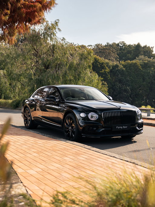 A Bentley Flying Spur staunchly resists the heat of an Australian day, its black livery monolithic and not a little sinister.

Approach more closely and details reveal themselves. Onyx black paint creates the deepest black finish imaginable. The electronically deployable flying-B mascot's wings illuminate as part of the car's welcome sequence. Headlamps take inspiration from cut-crystal glassware.

Enter the interior and linen hide lightens the tone. Bentley's craftsmanship in leathers, veneers, metalwork and textures is ceaselessly extraordinary – celebrated everywhere.

Tradition and craft meet technology. The Flying Spur is ready to transport you to other worlds.

Discover more via the link in our bio.

Retailer Instagram: @bentleysydney

#Bentley #BentleyFlyingSpur

Flying Spur (hybrid) WLTP drive cycle: Electrical consumption weighted, combined – 19.9 (kWh/100km). Fuel consumption combined with discharged battery – 26.4 (10.7) mpg (l/100km). Fuel consumption weighted, combined – 64.2 (4.4) mpg (l/100km). CO₂ emissions weighted, combined –100 g/km. CO₂ class weighted, combined – C. CO₂ class with discharged battery – G.