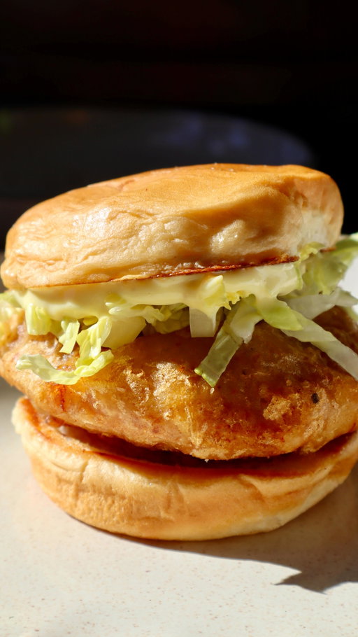 we got mcdonalds at homeeeee~ 

super crispy on the outside, juicy in the middle, and piled onto a soft toasted bun with lettuce and mayo 🤤

classic crispy mcchicken sandwiches recipe: 
 servings: 4 prep time: 25 minutes (+1 hour freezing) cook time: 10–12 minutes per batch

ingredients: chicken patties: - ½ lb chicken breast - ½ lb chicken thighs - 1 tsp salt - ½ tsp white pepper - ½ tsp onion powder - ½ tsp garlic powder - 1 tsp paprika

breading & wet batter: - 1 cup all-purpose flour - 1 cup cornstarch - 2 tsp baking powder - 1 tsp paprika - 1.5 tsp garlic powder - 1.5 tsp onion powder - ½ tsp black pepper - 2 tsp salt - 2 cups extra cold club soda (or beer)

sandwich assembly: 4 burger buns, toasted lettuce
sauce: ½ cup mayo 1–2 tsp mustard ½ tsp onion powder

instructions: - in a food processor, combine chicken breast, chicken thighs, salt, white pepper, onion powder, garlic powder, and paprika. pulse until smooth but still slightly textured—do not over-process. - divide the chicken mixture into 3–4 oz portions and shape each into a thin patty. place patties on a parchment-lined tray. - in a bowl, mix the dry breading ingredients: flour, cornstarch, paprika, garlic powder, onion powder, black pepper, and salt. - coat each frozen patty evenly in the dry mixture, shaking off excess. freeze for 60 minutes. - in a separate bowl, whisk together the remaining dry mixture with extra cold club soda (or beer) and baking powder until the batter reaches a thin syrupy consistency (thin enough to coat the chicken evenly, but not so runny that it completely slides off). add a little more club soda if needed. - heat oil in a deep pan or fryer to 350°f (175°c). dip each patty in the wet batter, letting excess drip off, then fry in batches until golden brown and cooked through, about 4–5 minutes per side. drain on paper towels or a wire rack. - to make the sauce, simply mix together mayo, mustard, and onion powder. taste and adjust to your liking. - toast buns lightly (use the mayo method!). assemble sandwiches with bun, fried chicken patty, lettuce, mayo, and top bun. serve and enjoy!

#mcdonalds #chickensandwich #fastfoodathome #homecooking #sandwich