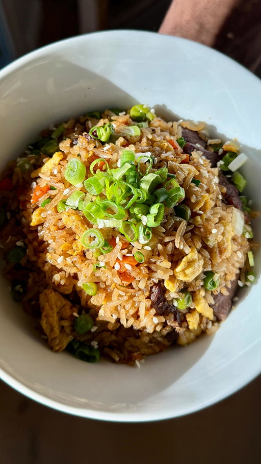 Steak Fried Rice
Recipe:
Steak Marinade:
- 13 oz chuck roast 
- 1 teaspoon soy sauce
- 4 teaspoons oyster sauce
- 4 tablespoons water
- 2 garlic cloves, grated
- 1/2 teaspoon sugar
- 1/4 teaspoon baking soda
- 1 tablespoon avocado oil

In a large bowl, combine all marinade ingredients except for the avocado oil. Add the beef, ensuring it’s fully coated. Let it marinate for at least 15 minutes.

- Heat the avocado oil in a wok over medium-high heat. Cook the beef until it’s cooked through and lightly charred. Remove and set aside.

Fried Rice:
- 4 tablespoons butter, divided
- 1 carrot, diced
- 1/2 onion, diced
- 3 garlic cloves, finely chopped
- 4 cups jasmine rice, cooked
- 2 teaspoons avocado oil
- 4 eggs, whisked and seasoned with salt and pepper
- 3 tablespoons soy sauce
- 1/2 teaspoon salt
- 1/2 teaspoon white pepper
- 2 tablespoons sesame seeds
- 4 scallions, chopped, plus more for topping

In the same wok, add 2 tablespoons of butter and let it melt. Add the garlic, onions, carrots, and green peas. Cook until the onions are softened and translucent.

- Add the rice to the wok and mix well. Cook for 1 minute, then push the rice to the side. Add 2 teaspoons of avocado oil and the eggs. Scramble the eggs and cook until they’re almost fully cooked. Mix the eggs with the rice.

- Add the soy sauce, salt, white pepper, and sesame seeds to the wok. Stir everything together until well combined.

- Return the beef to the wok and mix it in. Add the remaining 2 tablespoons of melted butter. Let it melt, then mix everything together and cook for another 2 minutes.

- Finally, add the chopped scallions to the wok and cook for another minute. Top with more chopped scallions and serve immediately. Enjoy your delicious steak fried rice!

#food #easyrecipe #foodies #healthyrecipe #steak