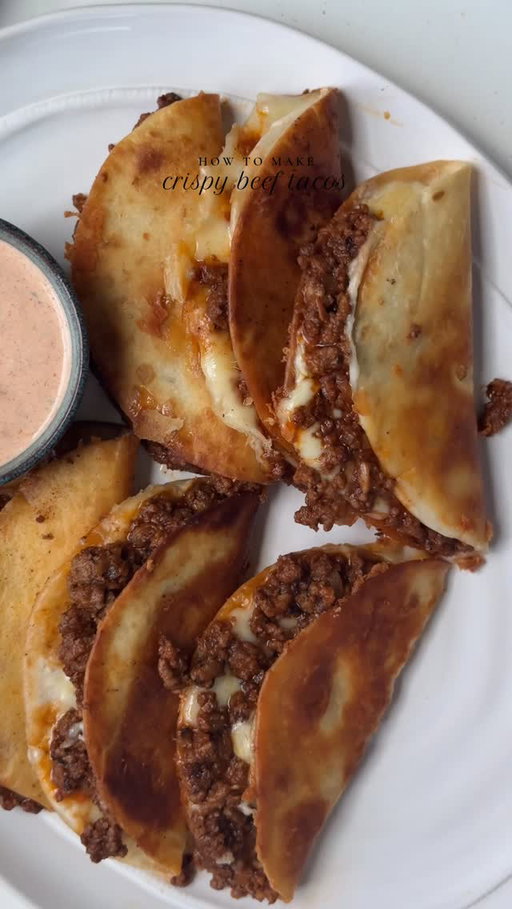 Crispy beef tacos with pico de gallo and cream taco sauce. 🌮 

Ingredients 

For the taco seasoning:

1 tbsp red chili powder 
2 tbsp garlic powder 
1 tbsp onion powder 
1 tbsp smoked red paprika powder 
1 tsp dried oregano 
1 tsp black pepper powder 
1 tbsp ground cumin
1 tbsp salt

For the beef:
2 lb ground beef (80 % lean , 20 % fat )
1 tbsp taco seasoning ( less or more, adjust to taste )
1 onion, diced
Salt to taste
1 tbsp clarified butter or oil
2 tbsp tomato paste
1/2 cup warm water 
1 tbsp minced garlic 

For the pico de gallo:

1 onion, finely chopped 
2 tomatoes, diced
1 tbsp freshly chopped cilantro 
2 tbsp lime juice 
Salt to taste
1 tsp black pepper 

For the taco sauce:

1/3 cup sour cream 
1/3 cup mayonnaise 
1/3 cup butter milk or water
1 juice of lime
1 tbsp taco seasoning ( less or more adjust to taste) 
1 tbsp dried parsley 

To assemble:

12-15 mini flour tortillas 
Oil for lightly frying tortillas
1 cup mozzarella cheese 

Method:

Make taco seasoning:

In a bowl combine salt , pepper, paprika, garlic powder, onion powder, cumin, chili powder and oregano. Mix to combine.

In a pan heat clarified butter add onion , sauté for a minute or until fragrant. Add minced beef. Cook on medium heat until it changes color, add fresh garlic mix to combine. Season with taco seasoning add tomato paste. Mix and sauté for 2-3 min. Taste and add more salt if needed Add warm water and cook for 8-10 min or until the beef is fully cooked and the water has evaporated.

Make salsa: In a bowl make salsa by mixing onions, tomatoes, cilantro, lime juice salt and pepper.

Make taco sauce: In a bowl add mayonnaise, sour cream, butter milk, add taco seasoning , lime juice and dried parsley. Mix until creamy and smooth.

In a pan heat oil on medium heat l, place tortilla , add shredded cheese, top it with beef one side. Close the tortilla by flipping half side. 
Cook until crispy and golden serve warm with salsa and taco sauce.

#tacos #beeftacos #recipe