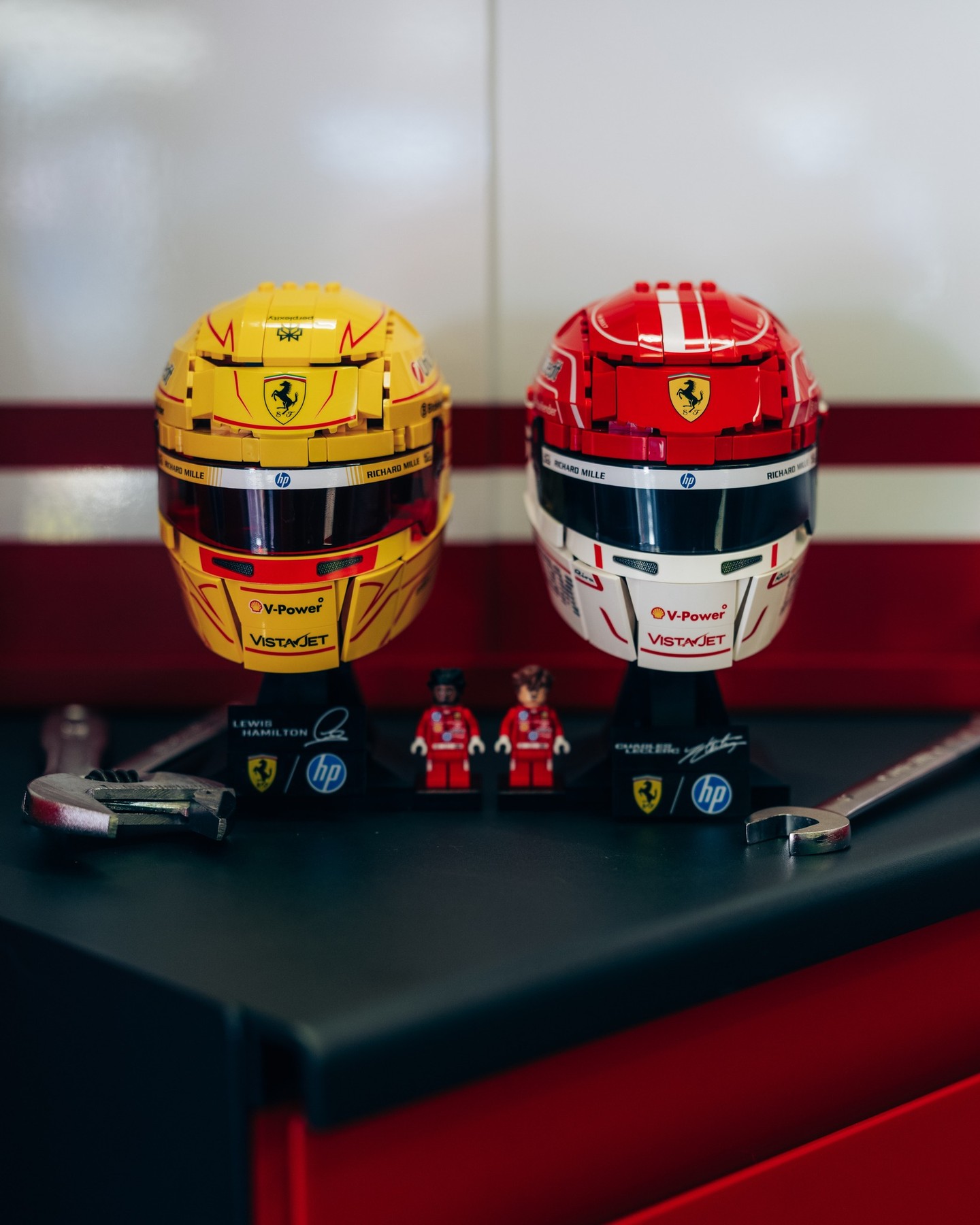 Lights out on the LEGO® Editions Scuderia Ferrari HP helmet sets for Charles Leclerc and Lewis Hamilton.