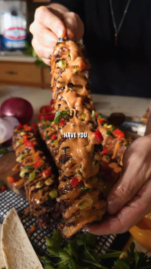 Tortilla Beef Kebabs

Recipe:
-In a bowl mix together:
2.5 lbs ground beef
1 chopped red bell pepper
1/4 chopped red onion
4 minced garlic cloves
1/3 cup chopped green onion
2 tbsp paprika
1 tbsp cumin
1 tbsp garlic powder
1 tbsp oregano
1 tbsp pepper
1 tbsp salt
-Cut the ends of large tortillas off to make a square shape.
-Add a thin layer of the beef mixture to 6 tortilla squares.
-Stack them on top of each other and cut into 4 sections.
-Flip them onto their side and then stick 4 skewers into the stack.
-Cut in between skewers to make kabobs.
-Sear on each side until 165F internal while painting with chili oil.
-Top with burger sauce and chopped peppers and onions for toppings.