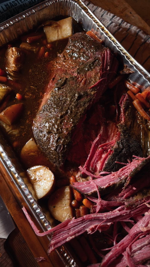 Corned beef for St. Patrick’s Day 🍀 

Recipe:
-Make the rub mixture by combining brown sugar and black pepper.
-Use mustard as a binder on the corned beef, then cover it with the rub mixture. 
-Put it onthe grill at 250F until the internal temperature reaches 165F.
-Transfer to a braising tray and add cabbage, carrots, and potatoes. Add in an Irish stout and beef broth. (The liquid should come up to just under half of the meat).
-Cover the tray with foil and return to the grill until reaching 210F internal.
-Remove, rest for at least 60 minutes, then enjoy.
