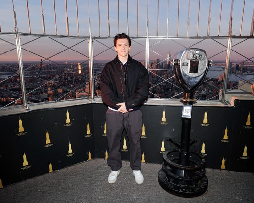 Tom Holland swung by the Empire State Building to light it up in red and blue and announce the new #SpiderManBrandNewDay trailer.