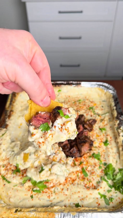 Mexican Street Corn Dip with steak. The perfect dip for college basketball 

Recipe ⤵️
2 - 8oz cream cheese 
8oz pepper jack
2 cans corn, drained 
1 bunch cilantro, diced 
1/4 cup sour cream (sub mayo)
Tajin seasoning 
1/2 can beer (you drink the rest 😉)

* Fire the grill up to 250° using @kingsford Original Briquettes
* Add all ingredients to a pan, place it on the smoker
* Cook it for about an hour or until all the cheese melts, stirring every 15 minutes
* Add some cojita cheese and Tajin to top it off and enjoy! 
* Once the cheese has melted, sear skirt steak over high heat till desired doneness and then after a 10 minute rest, cube it into bite size pieces
* Place the steak on top of the street corn dip and this is ready to serve
* Enjoy!
