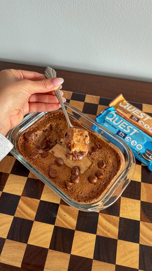 This single-serve chocolate chip brookie is too easy + made with one of my OG faves @questnutrition 🤌 #QuestPartner 

Ingredients: 
• 1 Chocolate Chip Cookie Dough Quest Bar 
• Splash of milk 
• 1 egg 
• 1 cup cottage cheese 
• 1 tbsp cocoa powder 
• 1 tbsp flour (I used oat) 
• Spoonful (or two) of chocolate chips 

How to make: Blend everything, pour into a microwave-safe dish, and place 1 Chocolate Chip Cookie Dough Quest Bar in the center. 

Microwave 60–90 seconds, checking every 15 so it doesn’t burn. Enjoy 🤍

 #TopQuestBarsAtCostco #OnAQuest #ItsBasicallyCheating

Available at Costco and via SameDay.Costco. Check the link in my bio to find availability at your local Costco.
