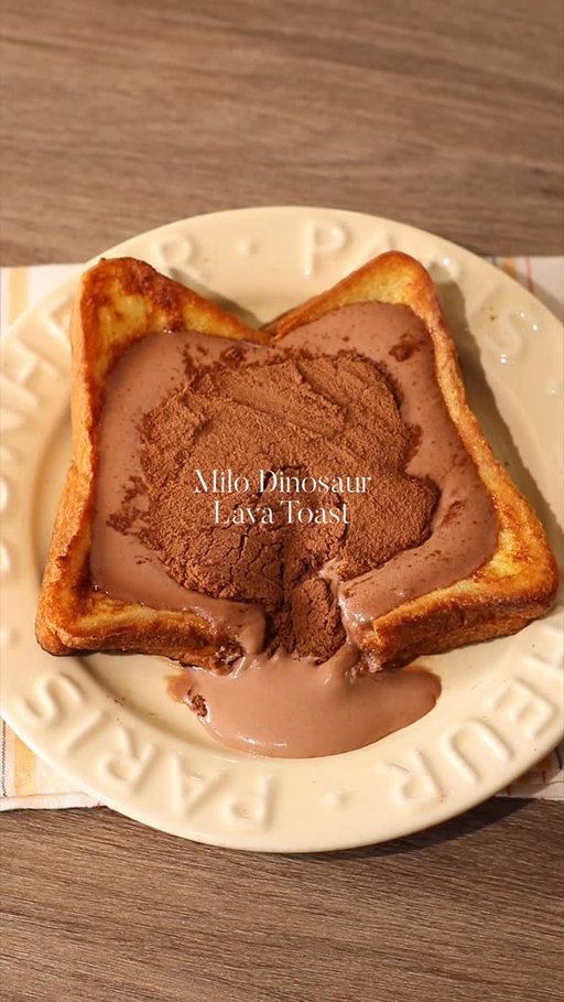🍫🍞 Milo Dinosaur Lava Toast

📝 Recipe

1 Egg
30ml • Milk
2 Slices • Bread
1 tbsp • Butter

Milo Cream 🥛:
20g • Milk
40g • Whipping Cream
1 Sachet • Milo Chocolate Powder

Instructions:

• French Toast Mixture + Bread
- in a bowl, crack open 1 egg, pour milk
- whisk to mix
- dip / coat the stacked bread in the egg mixture

• Cooking; Bread
- heat the pan with butter in medium heat
- once the butter melted, turn the stove into low heat
- fry the bread that has been coated with the egg mixture until both sides turn into golden brown

• Milo Cream
- in a jug, pour whipping cream and milk
- add milo powder and leave some for topping
- mix with hand mixer / milk frother

• Finishing; Milo Lava French Toast
- flatten the bread / french toast in the middle to create space for the cream
- pour milo cream onto the bread
- put milo powder on top

//

Milo Dinosaur as a drink ❌
Milo Dinosaur as a dessert ✅

—

#asmr #chocolatelover #breadrecipe #frenchtoast #easyrecipes