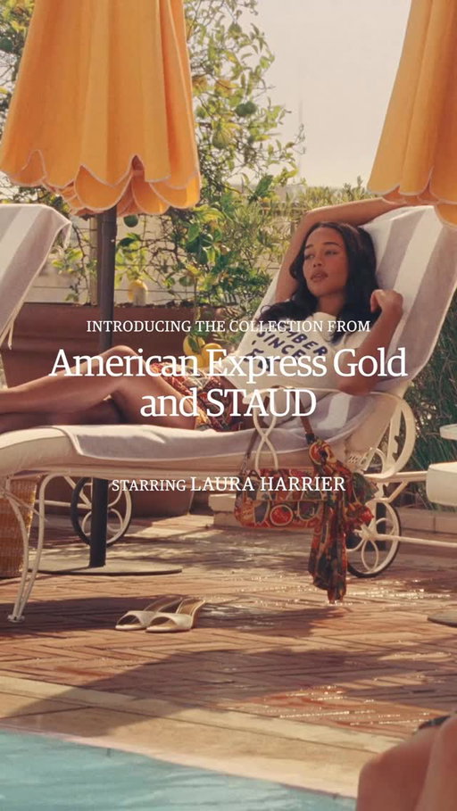 @lauraharrier was made for vacation life. The American Express Gold 60th Collection with STAUD is here, celebrating 60 years of elevated travel. Shop in stores or at the link in bio.