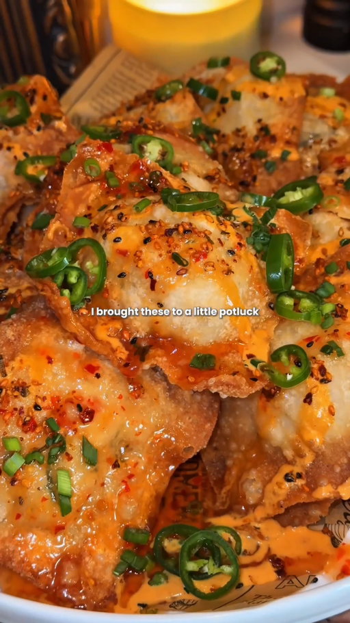 Comment CRAB for the recipe.

These stuffed crab rangoon nachos feature crispy fried wontons filled with creamy crab and cream cheese then topped with a spicy yuzu gochujang crema for the ultimate party appetizer.