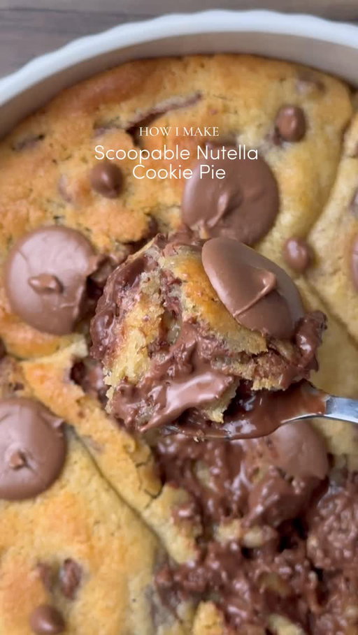Ooey-Gooey Scoopable Nutella cookie pie 🤤

You can now save this recipe to Osta🤎
To download the Osta app, search “Osta recipes” on the App Store or Google PlayStore🫶🏻

Yields: 8-9 Chunky Cookies
INGREDIENTS:
•115g cold chopped unsalted butter
•80g caster sugar
•80g light brown sugar
•220g chocolate chunks or chips( you can increase or reduce this according to your preference) 
•238g plain flour 
•½ tsp salt
•1 & ½ tsp baking powder
•¼ tsp baking soda
•1 whole egg + egg yolk 
•½ tsp vanilla
•Nutella 
INSTRUCTIONS:
•Cut cling wrap into small squares. Scoop ½ teaspoon Nutella onto individual cling-wrap squares. Fold to seal and freeze until solid. (Repeat for however many Nutella stuffed cookies you plan to make.)
•In a large mixing bowl, add the cold cubed butter and whisk until slightly creamy. Add the white sugar and light brown sugar, then whisk together until well combined and fluffy.
•Add the eggs, vanilla extract, and chocolate chips or chunks. Whisk until fully incorporated.
•Add the flour, baking powder, baking soda, and salt.
Gently mix until just combined, do not overmix.
•Portion the dough into 90g balls. Press a frozen Nutella piece into the centre of each dough ball, seal well, and roll into a smooth ball.
•Place the stuffed cookie dough balls onto a tray and freeze for at least 30 minutes (or overnight for best results).
•Preheat oven to 175-180°C (350°F).
•Take any shape baking dish circle, square, rectangle anything and line it with parchment paper. Arrange frozen cookie dough balls in it leaving some space between them.
•Bake for 15-20 minutes (timing depends on the type of pan) or until the tops are lightly golden while the centres remain soft and gooey.
•Remove from the oven and let cool slightly.
•Serve warm with ice cream and chocolate sauce enjoy!✨
NOTE: Store any extra dough balls in an airtight container or freezer bag and freeze for later. Whenever a cookie craving hits, bake straight from frozen 🫶🏻

#cookie #nutella #chocolate #fyp #explorepage