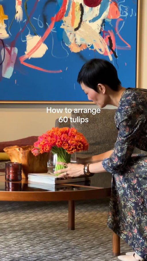 Arrange 60 tulips like this:
1. Clean most of the leaves off of each tulip. 
2. Line up each tulip side by side neatly. Try to keep all the stems straight. Tulip heads all the same height. 
3. Stack the tulips into a pyramid. 
4. Grab all the stems together. 
5. Use a clear hair tie and tie it once around the stems. 
6. Cut the stems straight across using a sharp knife. 
7. Straighten out and adjust each tulip. 
8. Measure to the vase and re-cut as needed. 
9. Use a penny for good luck (and to help keep the bacteria away). 

Find my favorite tools, lazy susan, and more on my ShopMy link in bio. 

#tulips #floristsofinstagram #flowerarrangements #rachelchofloral