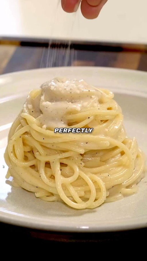 Perfect Cacio e Pepe Everytime....

Ingredients: (Per Serving)
- 100g Spaghetti
- 50g Pecorino Romano (Grated)
- 2g Freshly Ground Black Pepper
- 4g Corn Starch (Optional Clump Insurance)

Recipe:
1. Cook pasta in lightly salted water. Use less water than usual to increase starch concentration
	
2. Toast the pepper in a pan, medium heat, 30–60 sec until fragrant.

3. In a bowl, combine toasted pepper, grated cheese, and a scoop of starchy pasta water. (Optionally add the corn starch in a slurry with a spoonful of cold water)

4. Mix the sauce until smooth

5. Add the pasta and sauce to the empty pan and toss until smooth and creamy. 

6. Add splashes of pasta water as needed to thin out the sauce.

#cacioepepe #pasta #foodscience #italianfood