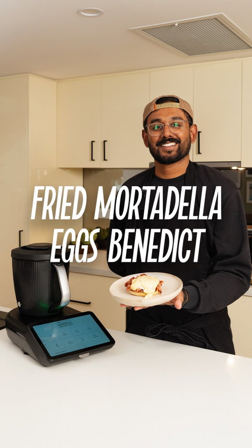 Mortadella Fried Eggs Benedict

Sous Vide Eggs
4–8 eggs
2 litres water
Ice water

Hollandaise
4 egg yolks
130g unsalted butter (cut into cubes)
20g lemon juice (about ½ lemon)
Salt to taste 
1 pinch cayenne pepper 

Base
200–300g mortadella
English muffins

Method
Start by cooking the eggs sous vide in the shell. Add 2 litres of water to the Thermomix and preheat to 75°C for 4 minutes. Attach the basket, place the eggs inside, and cook at 75°C for 8 minutes, then transfer to ice water and keep warm until ready to serve. Next, make the hollandaise by placing egg yolks, butter, lemon juice, salt, and cayenne pepper into the Thermomix with the butterfly whisk and cooking for 8 minutes at 80°C on speed 3. Taste for seasoning and keep warm at 70°C on speed 1 until ready. Fry slices of mortadella in a pan until crispy and toast the English muffins. To serve, place crispy mortadella onto the toasted English muffin, gently crack the sous vide egg on top, and finish with a generous spoonful of hollandaise. #ad #thermomixau