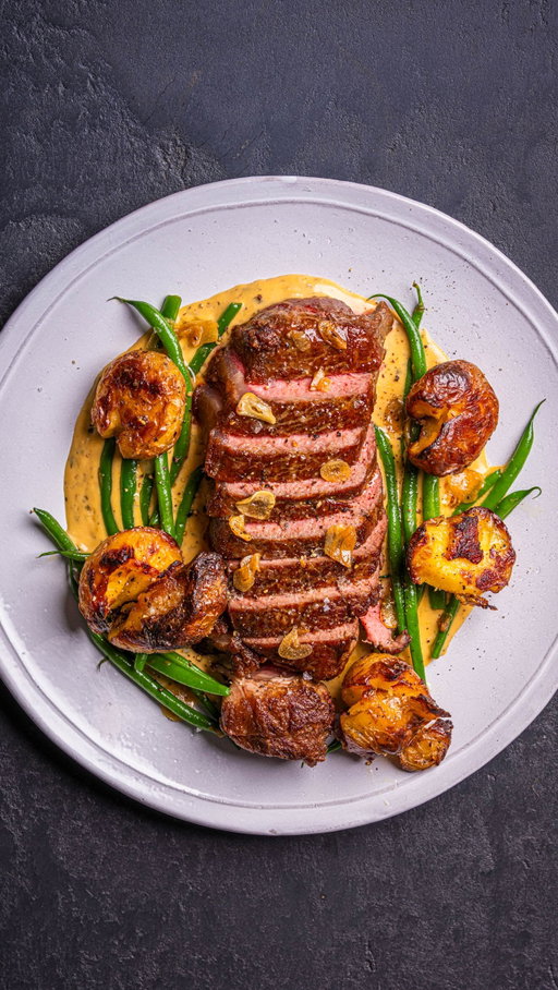 A béarnaise-inspired pan sauce using the flavour left in the pan after your steak. All three recipes below.

Pan used: 3QT Stainless Saucier from @madein . If you are looking to upgrade your cookware use the link in my bio to check out Made In's Stainless collection. These pans are durable, beautifully designed and trusted by real Chefs in some of the world's best restaurants.

STEAK

2 sirloin steaks, avocado oil, 2 tbsp butter, rosemary, thyme, 2 garlic cloves, salt & pepper
→ Forward sear, baste with butter, herbs & garlic, then into a 75°C oven to finish.

BÉARNAISE-INSPIRED PAN SAUCE (serves 2)

1 shallot (minced), 2 tbsp white wine vinegar, 120ml dry white wine, 120ml heavy cream, 1 tsp Dijon, 1–2 tbsp fresh tarragon, 1–2 tbsp cold butter, lemon juice (optional)
→ Soften shallot in the steak pan. Add vinegar and wine, reduce by half. Add cream, mustard and pepper, simmer until it coats a spoon. Off heat, stir in tarragon, then whisk in cold butter until glossy. Season, add lemon if needed.

GARLICKY HARICOTS VERTS (serves 2)

250g haricots verts, 1 tbsp butter, 2 garlic cloves (thinly sliced), lemon, salt & pepper
→ Blanch 2–3 mins, shock in ice water, pat dry. Sauté garlic in butter until golden, toss beans through, season and finish with lemon.

CRISPY SMASHED POTATOES (serves 2)

400g baby potatoes, 3 tbsp olive oil, salt & pepper
→ Boil until tender, steam dry, smash to 1cm. Roast at 220°C for 20–22 mins, flipping halfway, until golden. Finish with flaky salt.

#MadeInPartner