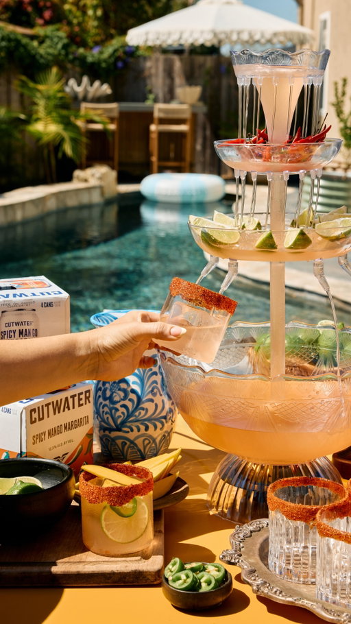 #ad When life gives you Spicy Mango Margaritas, serve them in a drink fountain 
 
The ultimate hosting hack is using @cutwaterspirits canned cocktails. They are perfectly mixed so all you have to do is crack, pour, & turn on your beverage fountain. 
 
Tips: 
Have glasses rimmed & ready for guests to grab & go 
 
Have a garnish station: fresh cut mango slices, lime wheels, or jalapeno slices 

Add some garnishes to your drink fountain, like spicy peppers, lime wheels or wedges, or even mango slices! 
 
Make sure your cans are cold when you pour! 
The only downside to this is that now I can’t serve my margaritas any other way….