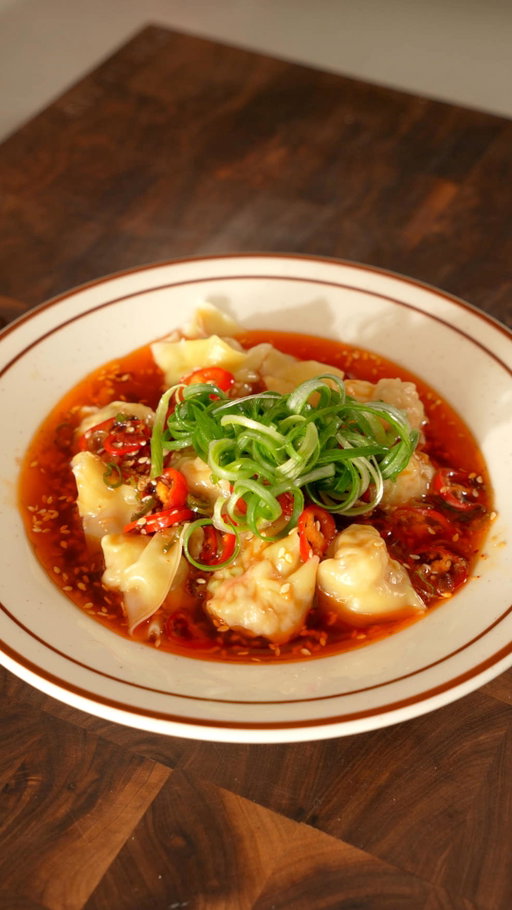 Leaking my mom’s secret Shrimp Wonton recipe 🥟

Ingredients

Wontons:
* 250g of Shrimp (70%) + Pork (30%)
* 1 tsp minced ginger
* 1 clove garlic
* 2 green onions
* 1½ tsp soy sauce
* 1 tsp sesame oil
* 1 tsp Oyster sauce
* ½ tsp salt
* ¼ tsp white/black pepper
* 1 tsp cornstarch
* 1/2 tsp Sugar
* Wonton wraps

Chilli Sauce:
* 2 chopped green onions
* 2 minced cloves garlic
* 1 tsp minced ginger
* 3-4 TBSP hot oil
* 1 red chilli
* 1 TBSP chilli oil
* 1 TBSP Chinese black vinegar
* 1 1/2 tsp Soy sauce
* 1 tsp sugar
* 1 tsp sesame seeds

Instructions

Wontons:
* Individually smash each shrimp before chopping them with the back of your knife for 2 minutes.
* Combine the shrimp with ground pork, minced ginger, chopped garlic, green onions, soy sauce, sesame oil, oyster sauce, salt, black pepper, cornstarch and sugar before slamming the filling into the bowl to make it bouncy.
* Wrap about 1 tsp of filling into a wonton wrap. Adjust depending on the size of the wonton wraps.
* Boil for 3-4 minutes until they float.

Sauce:
* Combine green onions, garlic and ginger to then pour hot oil over the mix.
* Finish the sauce with fresh red chilis, black vinegar, soy sauce, sugar, and sesame seeds.