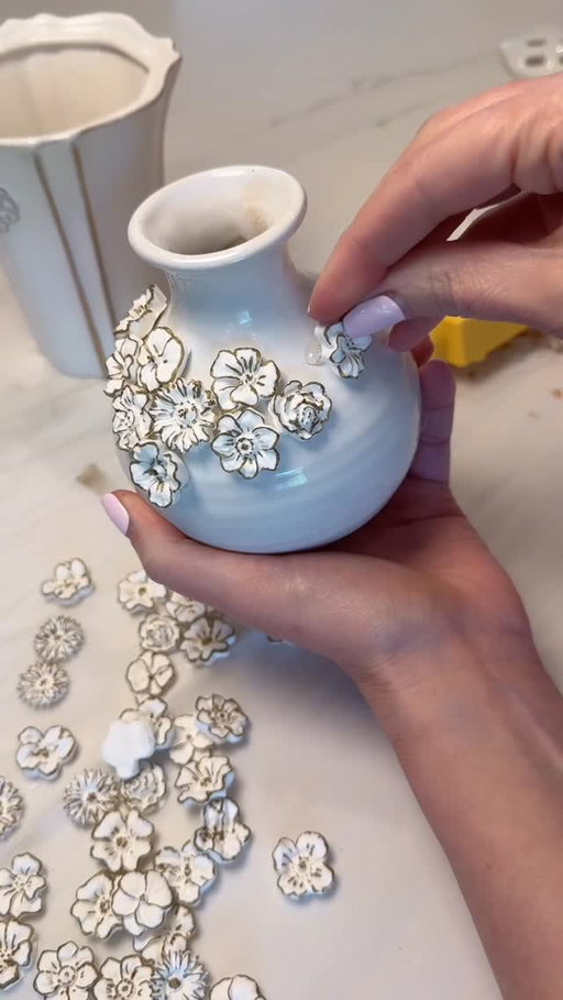 Designer Dupes - comment FLOWER for a link to the supplies I used — I was inspired by some mini white floral vase designs I saw online… but not for those prices. So I figured—why not try it myself? I pressed the clay straight into silicone molds, popped them out seconds later, and every tiny detail held perfectly. No waiting, no fuss. Let them dry overnight and they’re ready to go. I grabbed a gold paint pen to highlight the features and turned a few thrifted vases (one of my favorite things to collect for a couple bucks) into the cutest little vase accents. This would be such a fun craft night idea—prep a bunch of these flowers ahead of time, then have everyone bring a vase, jar, or trinket box. Just paint the flowers, glue, and create something totally custom🌸🌺🌼 

Easy, budget-friendly, and way cuter than anything I could have purchased. #diy #decor #handmade #thriftedstyle