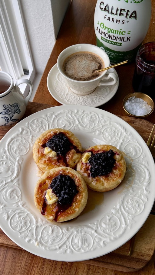 CLASSIC HOMEMADE CRUMPETS W/ BLUEBERRY COMPOTE

once you start making homemade crumpets…you will neverrr look back 😌 soft, fluffy, made with @califiafarms Organic Almondmilk & topped with jammy blueberry compote that melts into every bite 🫐 recipe below OR comment ‘RECIPE’ to get the link sent to you 🤎

Homemade Crumpets:
- 1 1/3 cups (180g) bread flour
- 1 cup (120g) all-purpose flour
- 2 tsp (8g) baking powder
- 1/2 tsp (3g) baking soda
- 1 tsp (6g) salt
- 3/4 cup + 2 tbsp (210ml) @califiafarms Organic Almondmilk, warmed to 110F
- 1 tsp (4g) granulated sugar
- 2 1/4 tsp (7g) active dry yeast
- 3/4 cup (180ml) warm water
Blueberry Compote:
- 2 cups (280g) blueberries, fresh or frozen
- 2 tbsp (30ml) maple syrup
- 2 tbsp (30ml) water
- 1 tbsp (15ml) lemon juice
- Zest of 1 lemon
- 1 tsp (4g) vanilla extract

Instructions:
Batter: In a medium bowl, sift together the dry ingredients. Set aside.
Pour the warm almondmilk into a small bowl. Add the sugar & yeast. Stir & allow to sit for 5-7 mins, until frothy.
Pour the yeast mixture into a large bowl along w/ the warm water & sifted dry ingredients. Whisk for 3-5 mins.
Cover the bowl & allow to sit at room temp for 30-45 mins, until increased in size. 
Compote: In a saucepan over medium heat, add the blueberries, maple syrup, water, lemon juice & zest. Stir.
Bring to a simmer. Turn heat to low & simmer for 10-13 mins, stirring occasionally, until thickened. �Once you stir & a trail is left at the bottom of the pan, the compote is done! Remove from heat & stir in vanilla. Set aside.
Heat a large skillet over medium-high heat & grease w/ vegan butter. Brush your crumpet rings w/ melted vegan butter. *See alternatives for rings on my website.*
Pour ~1/4 cup the batter into the rings, filling them ~1/3 of the way.
Cook the crumpets for ~2 mins, until bubbles form. Then immediately turn the temp down to medium & continue to cook as the bubbles pop.
Once the tops of the crumpets are set & there is no raw batter, flip the them over. Cook on the other side for 1-2 mins, until golden.
Remove the rings, then remove them from the pan. Repeat.
Serve the crumpets warm w/ blueberry compote & flaky salt. 
Enjoy!

#califiapartner