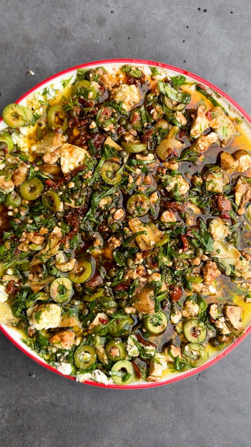 Loaded Olive Oil is exactly as heavenly as it looks! I have seen countless videos of people making various versions of this flavor-packed plate and decided it was time to give it a try with what I had in the fridge. Feel free to customize your own with what you have and to your liking. Wow. I will be making this every time I host!
-
3/4 cup extra-virgin olive oil
1/4 cup balsamic vinegar
1/4 cup capers
1/4 cup chopped marinated artichoke hearts
1/4 cup sliced green olives
5 oz feta cheese, crumbled
2 tablespoons chopped sun-dried tomatoes
2 tablespoons chopped fresh dill
2 tablespoons fresh oregano leaves
2 tablespoons thinly sliced basil
1 tablespoon Calabrian chili pasta
2 garlic cloves, minced
1/2 lemon, juice
Flakey sea salt, to taste
Freshly cracked black pepper, to taste
1 large loaf of sourdough bread

#loadedoliveoil #oliveoil #easyrecipe #food #cooking