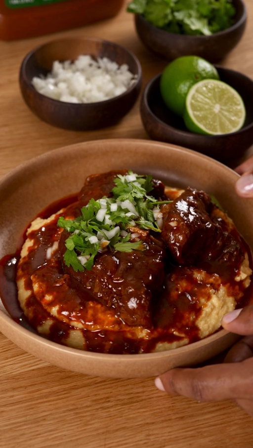 Birria, reimagined. Braised short ribs over creamy grits, built on the NEW @knorr Ancho Birria Ready-to-Use Sauce for deep, layered flavor. This is the kind of dish that earns a spot on the menu. #KnorrPartner 
Ingredients
For the Short Ribs
2lbs lbs bone-in beef short ribs
Salt + black pepper
1 tbsp oil (for searing)
4 cups Knorr Ancho Birria Ready-to-Use Sauce
2 cups beef broth
4 cloves garlic, smashed
½ onion, roughly chopped
1 bay leaf
For the Creamy Grits
1 cup stone-ground grits
4 cups water or chicken stock
1 cup heavy cream
2 tbsp butter
1 cup shredded cheese (cheddar or Monterey Jack)
Salt to taste
To Finish
Fresh cilantro, chopped
Diced white onion
Lime wedges charred! 

Instructions
1.Pat your short ribs dry and season generously with salt + pepper. Heat oil in a heavy pot or Dutch oven over medium-high heat.
2.Sear ribs on all sides until browned about 3–4 minutes per side.
3.Lower heat slightly and add garlic, onion. Let those get fragrant for 1–2 minutes.
4.Pour in Knorr Birria Sauce , beef broth, and bay leaf
5.Stir, nestle the short ribs back in, cover, and simmer low for 2.5–3 hours
 (or 325°F oven same time) until fall-apart tender.
6.Make the Creamy grits,Bring liquid to a boil, then slowly whisk in grits.
7.Lower heat and cook, stirring often, for about 20–25 minutes until thick + tender. Butter, heavy cream, cheese. Season to taste rich, smooth, and cheesy.
 8.All that’s left is to plate it up! Spoon creamy grits into a bowl.  Top with that saucy birria short rib. Finish with cilantro, diced onion! 
9.Enjoy!!