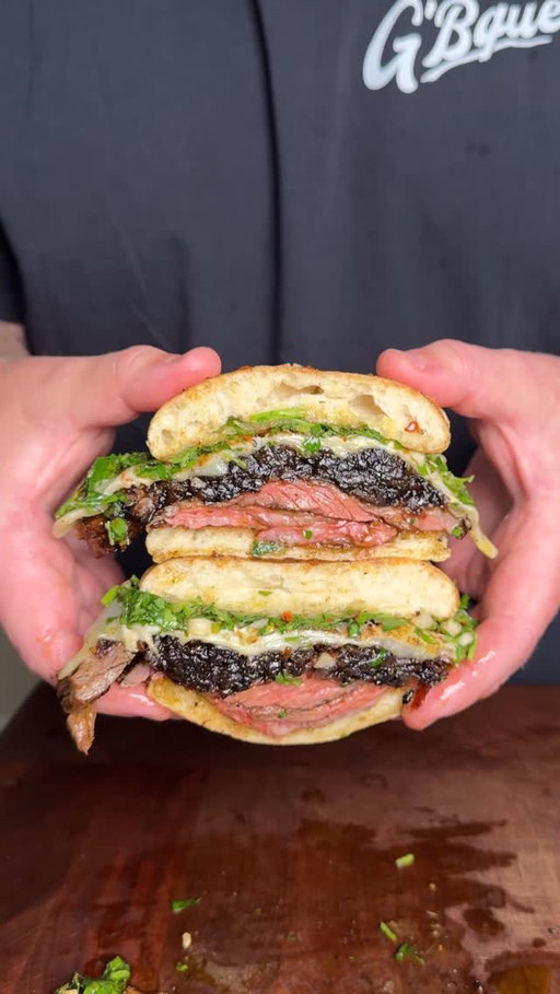 Steak sandwich with caramelize onions and chimichurri. This was so good! Recipe ⤵️

* Season skirt steak with your favorite steak rub
* Fire up the grill to high heat, using @Kingsford Original Charcoal Briquettes 
* Sear steak on the grill at high heat, flipping every 30 seconds until it reaches 125° internal temperature (or desired doneness) 
* This will also the crust to develop without overcooking it
* Once your steak is done let it rest for 10 minutes
* Caramelize 2 red onions with 2 tbsp butter and 2 tbsp Worcestershire while the steak rests
* Slice your steak and build your sandwich
* Ciabatta bread, steak, caramelize onions, pepper jack cheese and chimichurri below
* Slice and enjoy!

Chimichurri Recipe 
* 1 bunch parsley
* 1 bunch cilantro
* 1 head roasted garlic
* Juice from 1 lemon
* 1 tsp salt
* 1 tsp red pepper flakes
* 1/4 cup olive oil
* 3 tbsp red wine vinegar
* Adjust oil/vinegar to consistency preference