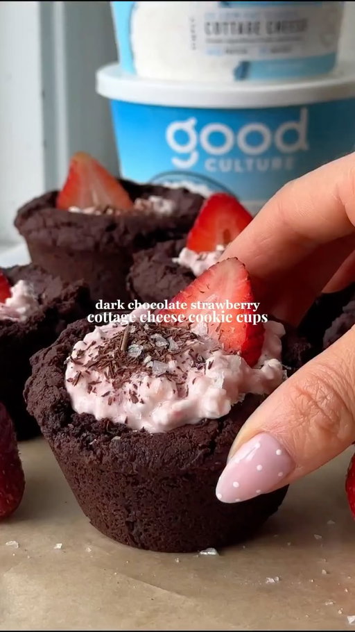 #GoodCulturePartner Dark chocolate cookie cups filled with the creamiest strawberry center 🍓🍫

Made with @good_culture Cottage Cheese for that ultra-thick & creamy filling that pairs perfectly with the fudgy chocolate brownie cookie. 

They’re soft, chocolatey, rich,and honestly so insanely delicious with an added boost of protein. 

FULL RECIPE BELOW
Dark Chocolate Strawberry Cottage Cheese Cookie Cups
Ingredients 
Cookie Cups
½ cup unsalted butter, melted
½ cup granulated sugar
⅓ cup brown sugar
½ cup dutch-processed cocoa powder
¼ cup unsweetened, plain yogurt
1 ¼ cups all-purpose flour
¾ tsp instant espresso powder
¾ tsp baking soda
½ tsp kosher salt
½ cup dark chocolate chips
⅓ cup lightly crushed freeze dried strawberries 
Filling
1 cup Good Culture 2% Cottage Cheese
¼ cup strawberry jam 
1 tsp vanilla extract 
Topping - fresh strawberries, shaved chocolate, flaky sea salt 

Directions 
Preheat oven to 350°F. Grease half of a 12-cup muffin tin with non-stick cooking spray (this recipe makes 6 cups). 

In a large mixing bowl, whisk together butter, sugars, cocoa powder, and yogurt. Add flour, espresso powder, baking soda, and salt. Combine until a soft dough forms. Fold in chocolate chips and freeze dried strawberries. 

Scoop 2 ½-3 tbsp dough into each muffin cup and lightly press dough down so it sits evenly in the bottom (do not press up the sides yet). 

Bake for 14-17 min until edges are set. The center should still look soft and slightly underbaked. 

Remove from oven and immediately use the bottom of a ¼ cup measuring cup to gently press into the center of each cookie to form a cup shape. 

Cool cookie cups for 10 minutes before carefully removing. Cool completely before filling. 

To make the filling: Whisk together all ingredients until smooth. Fill cooled cookie cups with filling and top with fresh strawberries, chocolate shavings, and flaky sea salt. 

TIP to make this recipe lower in sugar: substitute sugars for monkfruit or your favorite sugar alternative and lower chocolate chip amount to ¼ cup or omit completely. Also use no sugar added jam. 

#cottagecheese #cookiecups #darkchocolate #dessertrecipe