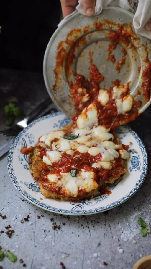 One of the most delicious parts of a good Chicken Parm is the textural difference between the crispy outside of the chicken with the smoothness of the bright tomato sauce and melty cheese. Instead of breadcrumbs, this version is crusted with shredded potato (a perfect gluten-free option!) that crisps up beautifully. Additionally, I heat the sauce and cheese separate from the chicken to pour on top restaurant-style just before serving. Enjoy this weeknight dinner with warm bread or pasta to soak up extra sauce!
 
Potato-Crusted Chicken Parmesan
 
Ingredients:
For the Tomato Sauce:
2 tbsp olive oil
1 medium yellow onion, diced
2 cloves garlic, minced
28 oz San Marzano crushed tomatoes
1 ¼ tsp salt, more to taste
1 tsp dried or 1 tbsp fresh oregano
1 tbsp fresh basil
1 tsp sugar
¼ tsp garlic salt
½ cup water or chicken broth
 
For the Chicken:
3 large or 4 small chicken breasts
2-3 russet potatoes
Shredded Parmesan cheese
1 tsp salt
1 tsp ground pepper
2 eggs
½ cup flour
½ tsp salt
½ tsp pepper
½ tsp garlic salt
1 tsp paprika
 
For Assembly:
Olive oil or neutral oil for frying
Fresh or shredded mozzarella
Freshly shredded Parmesan cheese
Fresh basil
 📌the rest is in the pinned comment