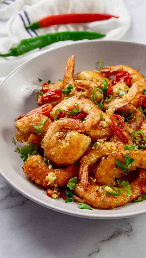 If you need something quick and easy to make for dinner, make this Salt & Pepper Shrimp 🦐 

[SAVE & SHARE this recipe] 

I’ve been seeing this all over my timeline, so I had to try it and I’m so glad I did. It’s a Cantonese dish that’s traditionally made with the shell on, but I went ahead and peeled mine so it’s easier to eat. 

Ingredients 
	•	Shrimp (cleaned + deveined)
	•	Cornstarch
	•	Olive oil
	•	1 tbsp butter
	•	Jalapeño
	•	Red chili pepper
	•	Garlic (minced)
	•	Salt, pepper, sugar

Seasoning (season to your liking, here’s what I used):
	•	Garlic powder
	•	Trader Joe’s garlicy spicy seasoning
	•	Paprika
	•	Cowboy butter seasoning

Salt + pepper mix:
	•	1 tsp salt
	•	1 tsp pepper
	•	2 tsp sugar

Directions:
Season your shrimp to your liking (I used the seasonings above), then toss in cornstarch until fully coated. This is what gives it that crispy texture.

Heat olive oil in a pan and lightly fry shrimp for 2–3 minutes per side until golden. Remove from the pan.

To cut down on the fat, I removed most of the oil from the pan, then add in about 1 tablespoon of butter. Add garlic, jalapeño, and Thai chili and sauté for about 30 seconds.

Add the shrimp back in, sprinkle in your salt, pepper, and sugar mixture, and toss everything together for 1–2 minutes until fully coated.

Then enjoy!! I served this with a side salad to feel healthier 😂 let me know if you make this.